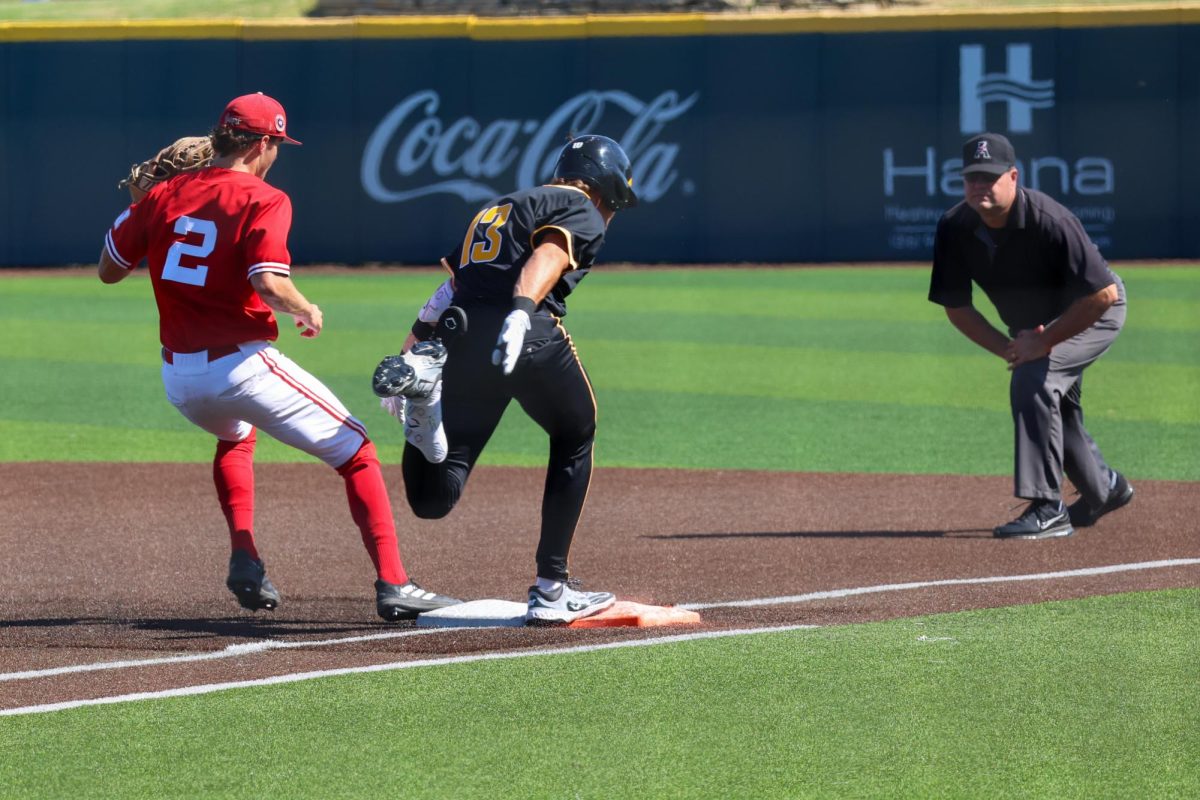 Senior Drew Bugner (13) beats the force out at first base on Saturday, Sept. 27, 2025, in Wichita, Kansas. Bugner transferred from Pittsburg State in Pittsburg, Kansas.