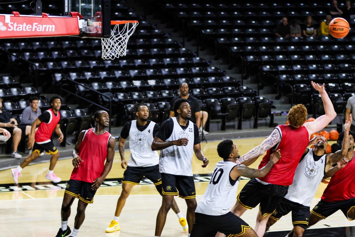 Men's basketball players fight for possession of the ball during an open practice on Sept. 18. Wichita State will later host Drake in a charity scrimmage on Oct. 11.