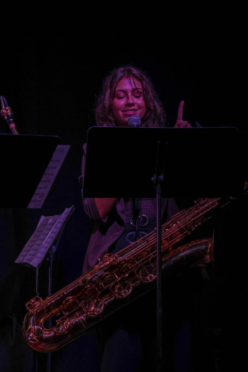 Baritone saxophone player Zoe Isom addresses the crowd during a Wichita State jazz ensemble performance on Sept. 21. The performance took place at Walker's Jazz Lounge.