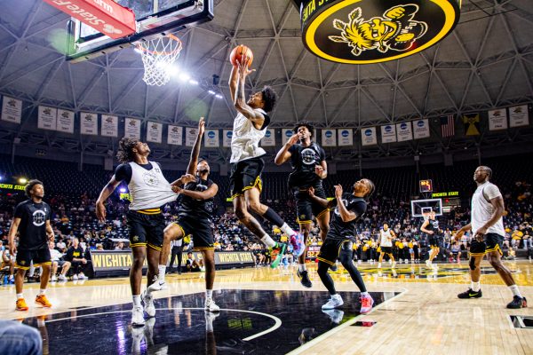 Wichita State junior Jaret Valencia flies to the hoop during men's basketball's scrimmage at Shocker Madness on Saturday, Oct. 4, at Koch Arena. Valencia drained a 3-pointer at the buzzer to help the "White" team win, 15-14.