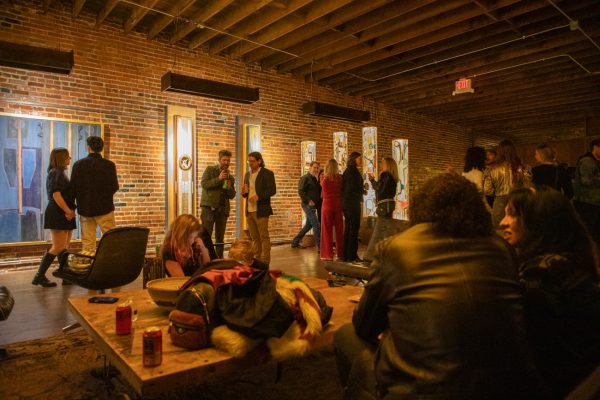 Gallery attendees socializing in the center space of the studio. It was John and Connie Ernatt's first show in 10 years. The opening took place at The Diver Studio at 424 S Commerce St.
