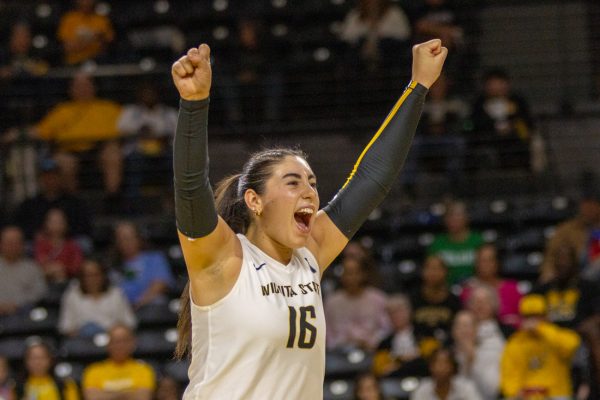 Wichita State volleyball junior setter Jordan Heatherly (16) cheers after a point against Tulane on Oct. 24. The Shockers won, 3-1.