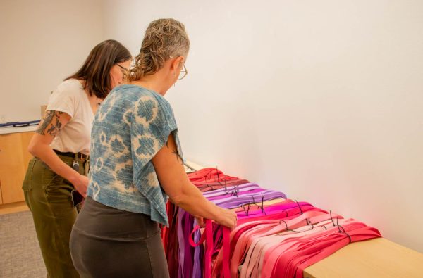 Guests pick their hue of fabric strip at the Scrollathon event, hosted by the Ulrich Museum of Art. Scrollathon is a nationwide project that aims to tell the stories of the participants.