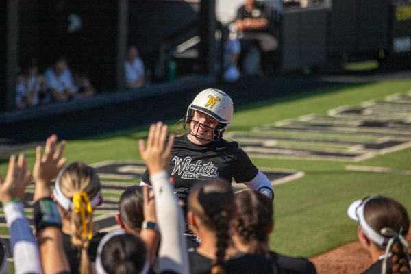 Wichita State softball sophomore Aeryn Shuman (78) greets her teammates at home plate with a grin after hitting a home run against Emporia State on Sunday, Oct. 5, 2025, at Wilkins Stadium. Shuman hit one home run in her freshman season at Central Arkansas.