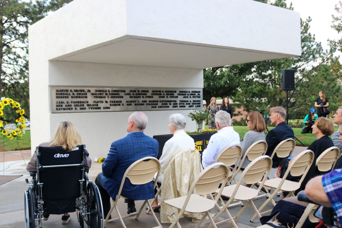 Close family and friends sit in front of the main memorial structure during the Memorial '70 ceremony on Oct. 2, 2025, in Wichita, Kansas. Thirty one WSU football players, staff, administrators and family members died in a plane crash in 1970.