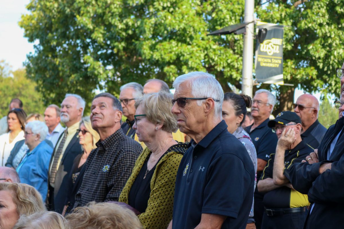 Family and friends sit in silence remembering the lives lost near at the Memorial '70 ceremony on Oct. 2, 2025, in Wichita, Kansas. The ceremony honored the Wichita State football team that crashed near Silver Plume, Colorado in 1970 on the way to a game.