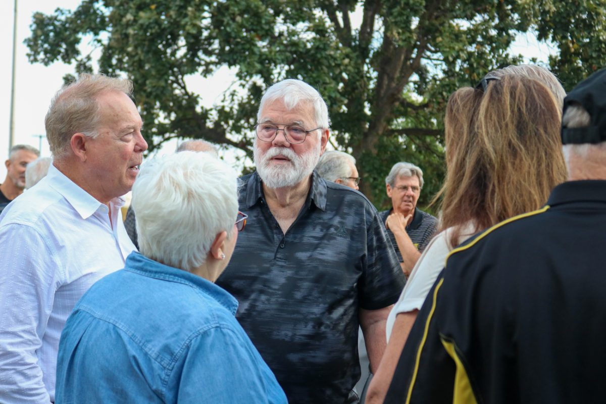 Friends and family privately converse with each other at the conclusion of the Memorial '70 ceremony on Oct. 2, 2025, in Wichita, Kansas. The ceremony is held annually to commemorate the 31 Wichita State football players, coaches, administrators and family members who crashed on the way to a game in 1970. 