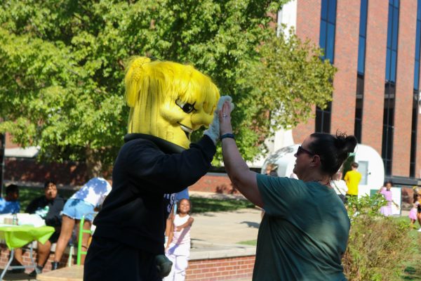 WuShock high-fiving a member of the Wichita State community. The Shocktoberfest Brew Garden was an event that brought breweries, food trucks, vendors, local music and fun activities for the Shocker community. 