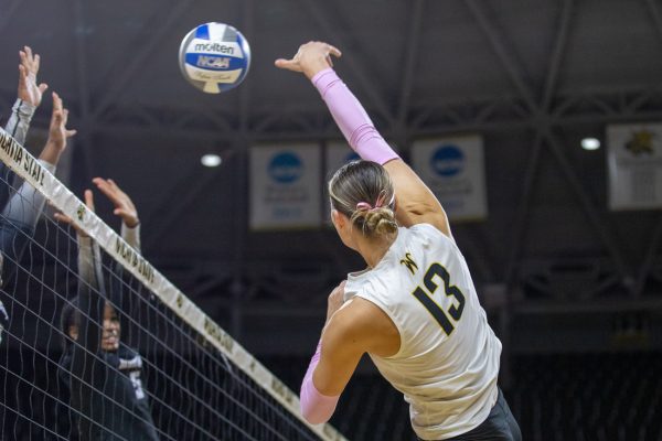 Wichita State volleyball senior Emerson Wilford (13) spikes the ball against the Memphis Tigers on Friday, Oct. 10, 2025, at Koch Arena. The Shockers won, 3-0.