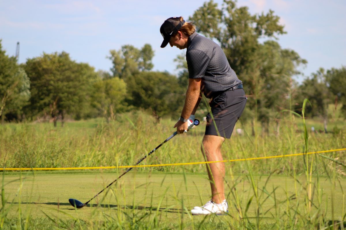 Wichita State men's golf freshman Rhett O'Rear lines up a tee shot at the Grier Jones Invitational on Sunday, Oct. 5, 2025, at the Sand Creek Station golf course in Newton, Kansas. O'Rear finished in 38th place, with 221 strokes (+5).