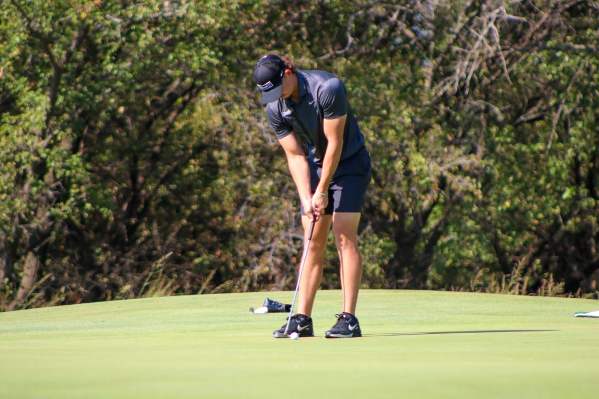 Wichita State men's golf senior Mitchell Revie begins his putting stroke at the Grier Jones Invitational on Sunday, Oct. 5, 2025, at the Sand Creek Station golf course in Newton, Kansas. Revie finished in 97th place, with 238 strokes (+22).