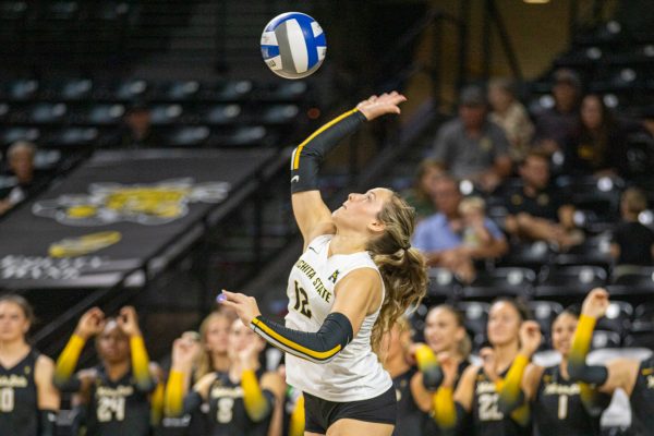 Wichita State volleyball sophomore Grace Hett (12) serves the ball to UAB on Sunday, Oct. 12, 2025, at Koch Arena. Hett made one service ace against the Blazers.
