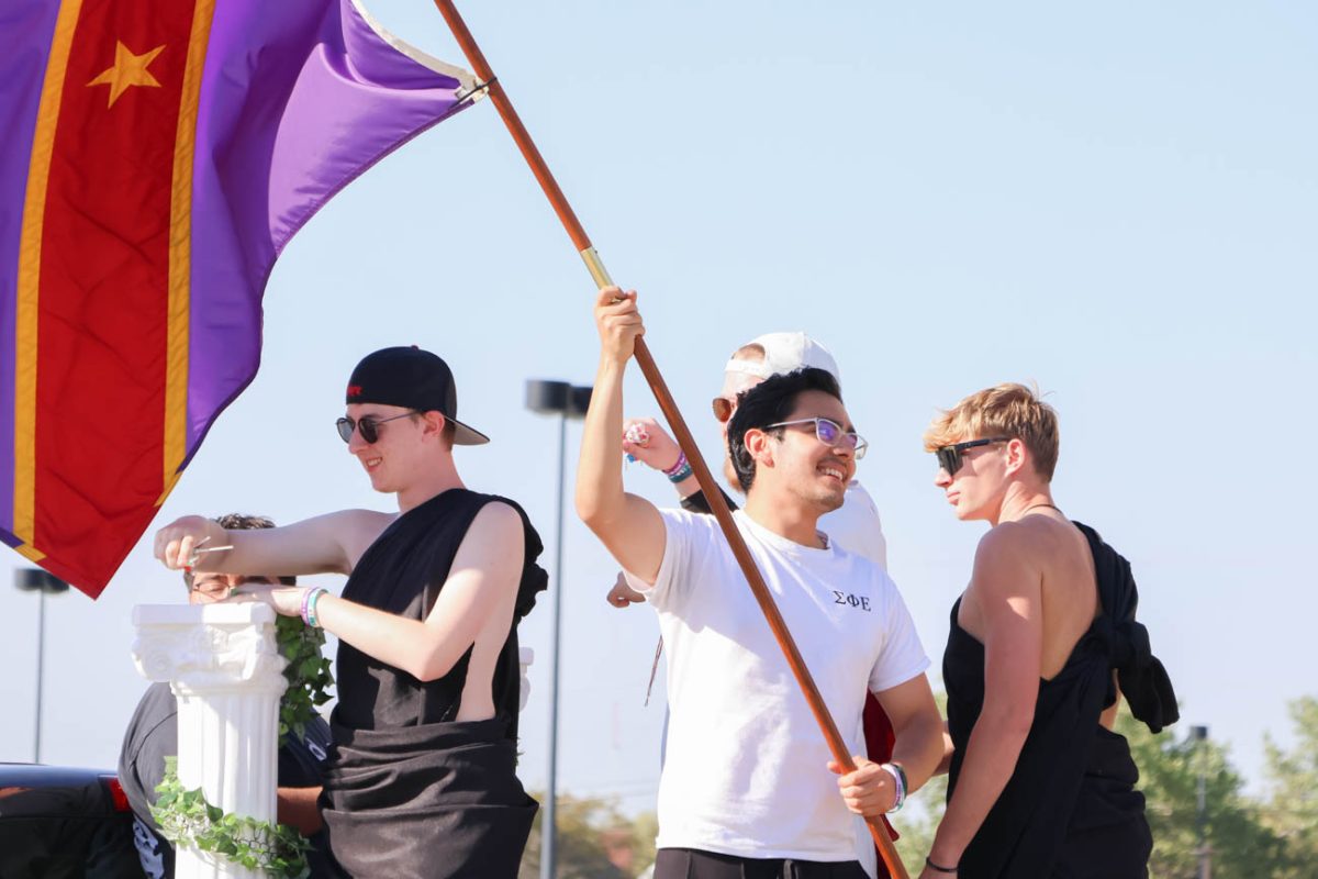 Members of the Wichita State chapter of Sigma Phi Epsilon stand atop their float in the Shocktoberfest parade. Several Greek organizations, academic colleges and other groups participated in the parade on Oct. 4. 