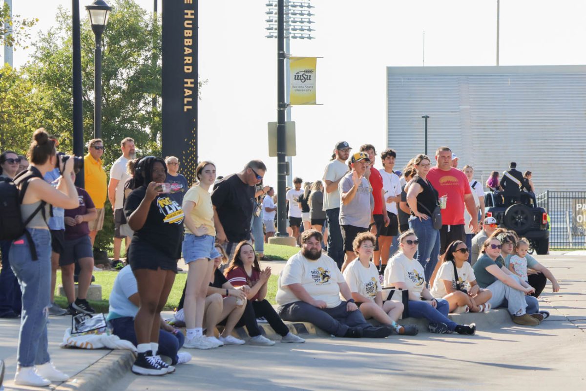 Onlookers watch as the Shocktoberfest parade approaches on Oct. 4. The day started with an entrepreneur market and ended with Shocker Madness in Koch arena following the parade. 