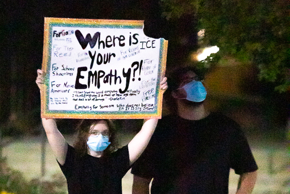 Protestors hold signs to protest the vigil for Charlie Kirk. The group assembled on the RSC North Lawn. "We're not celebrating his death, we're not happy he died, but we're trying to make a point," one protestor said who declined to give their name.