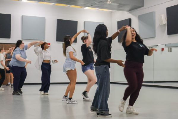Atendees of the dance through the diaspora event learn to execute a turn correctly while dancing the bachata. The event took place Thursday, Oct. 9 in the Heskett Center.