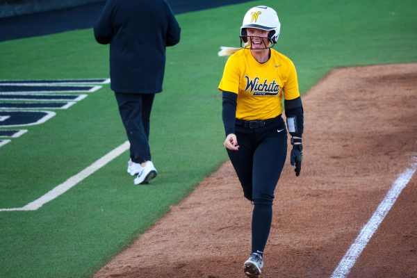 Wichita State softball freshman Kammie Smith (9) screams before she crosses home plate against Southern Nazarene on Wednesday, Oct. 22, 2025, at Wilkins Stadium. Smith hit a two-run home run in the scrimmage against against the Crimson Storm.