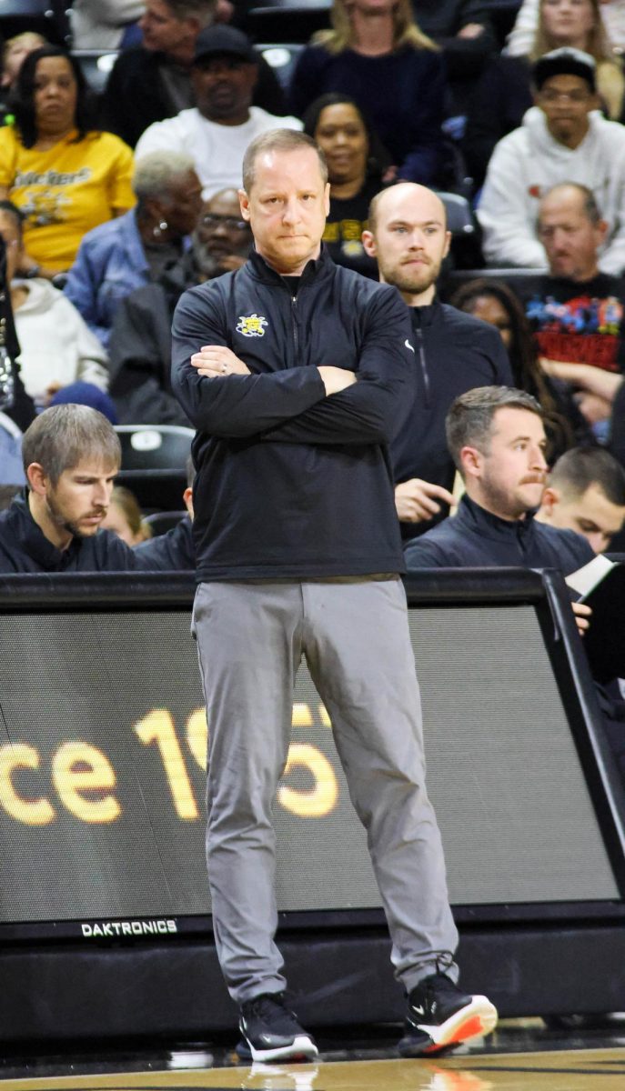 Wichita State men's basketball coach Paul Mills inspects the court during a game against Prairie View A&M on Nov. 8. This is Mills' third year as head coach.