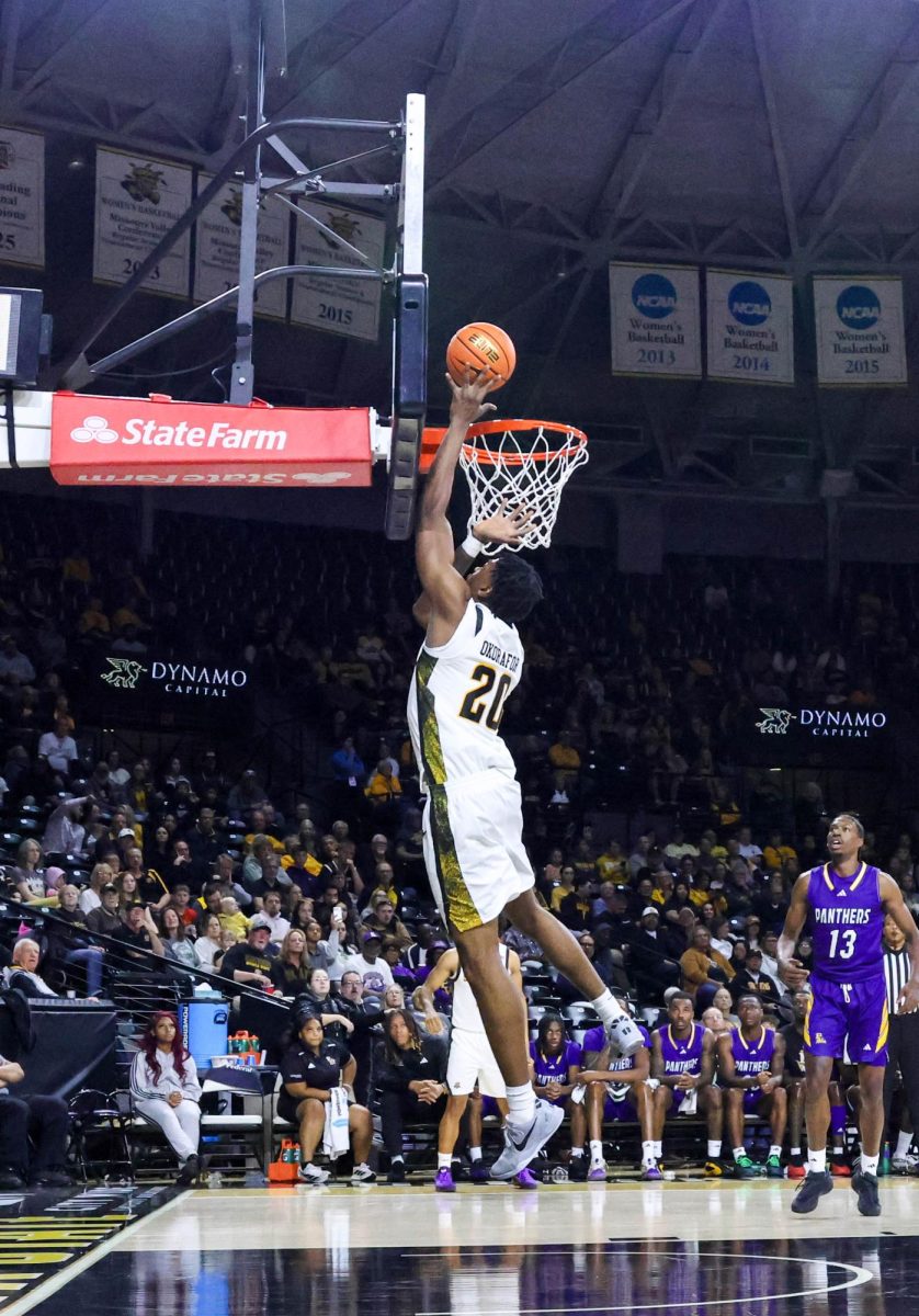 Wichita State senior Emmanuel Okorafor (20) jumps for a layup on Nov. 8. The Shockers beat Prairie View A&M, 105-62.