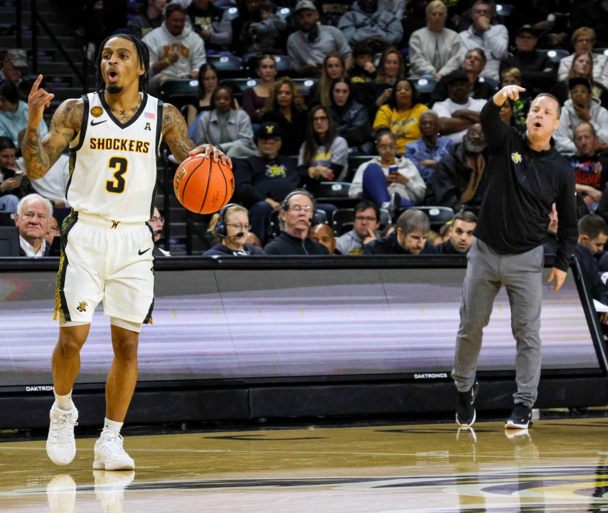Wichita State junior Dre Kindell (3) and head coach Paul Mills signal a play during a men's basketball game on Nov. 8. Kindell finished the game with 15 points.