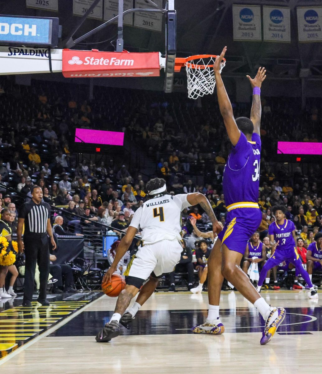 Wichita State redshirt freshman TJ Williams (4) drives past the basket during a game against Prairie View A&M on Nov. 8. Williams finished the night with 14 points.