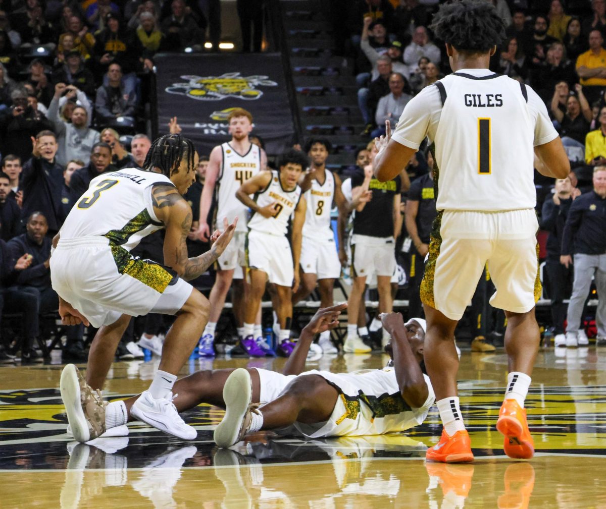 Wichita State junior Dre Kindell (3) and senior Kenyon Giles (1) celebrates with senior Karon Boyd (0) after a made 3-pointer on Nov. 8. Boyd was fouled on the play and converted the free throw.