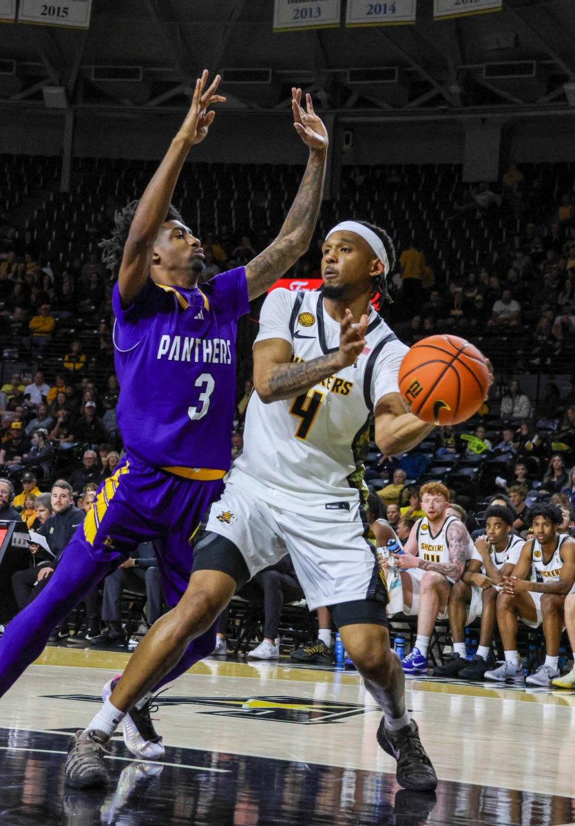 Wichita State redshirt freshman TJ Williams (4) passes the ball as a Prairie View A&M player tries blocking him on Nov. 8. Williams led the Shockers with five assists in the 105-62 win.