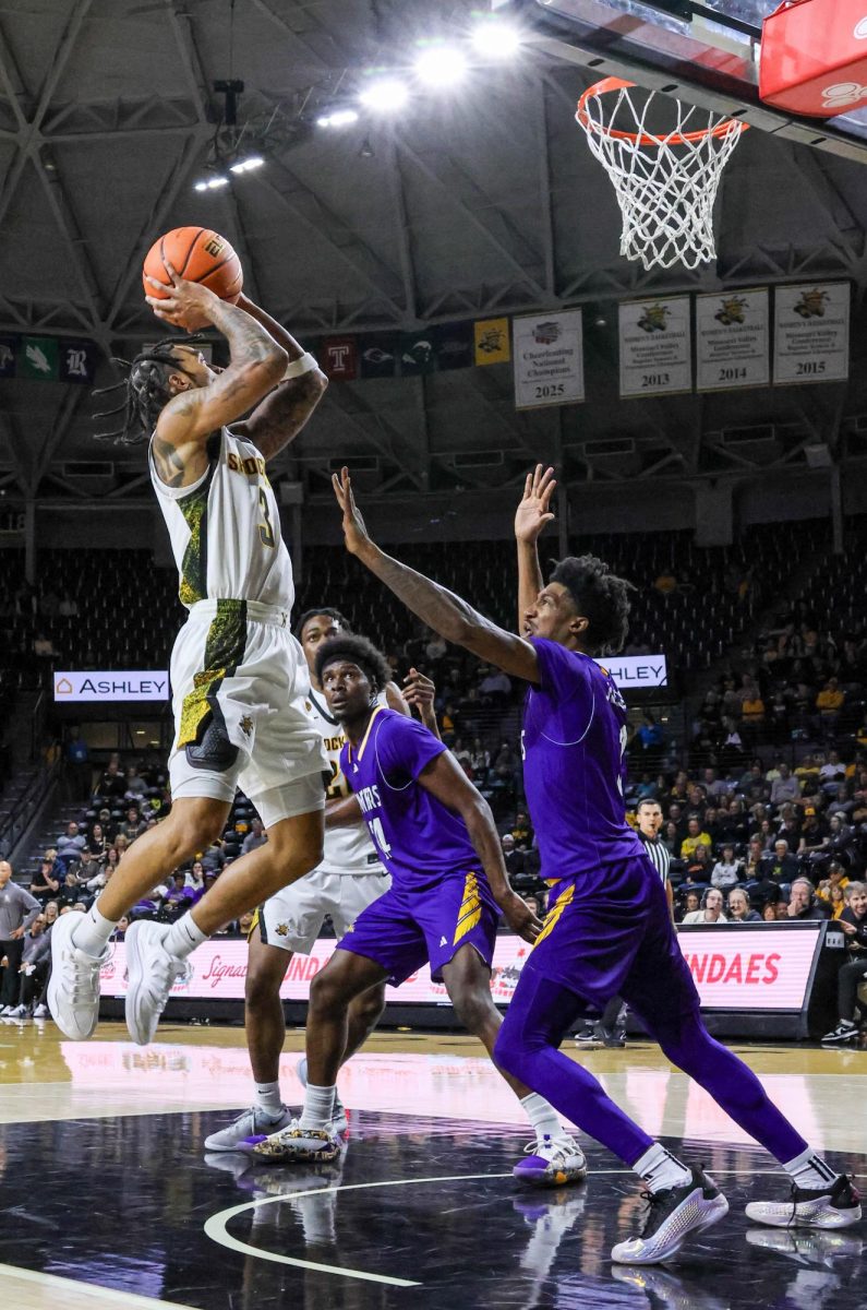 Wichita State junior Dre Kindell (3) shoots the ball as two defenders attempt to block him on Nov. 8. Kindell finished with 15 points in the win.