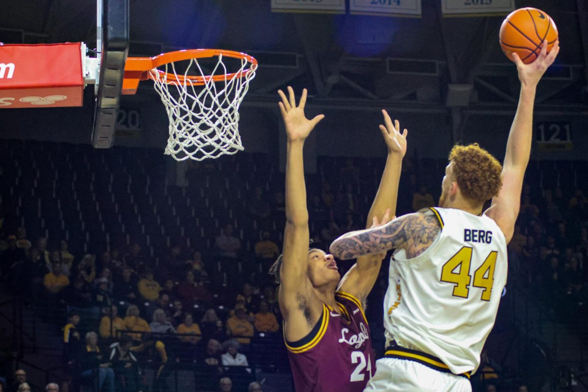 Wichita State men's basketball center Will Berg (44) shoots a hook shot over Loyola-Chicago's center Rubin Miles (24) on Nov. 13. Berg finished with 13 points in the Shockers' 95-74 win.