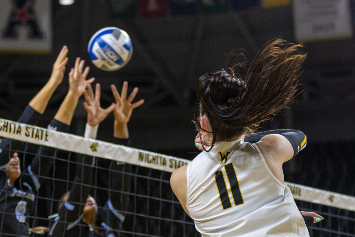 Wichita State volleyball junior outside Sydney Dunning (11) sends an attack over the net against Tulane on Oct. 24. (File photo)