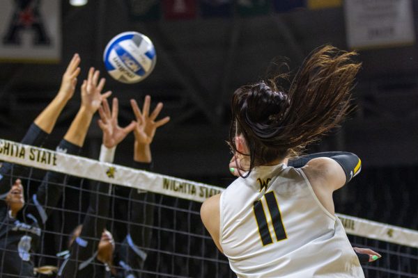Wichita State volleyball junior outside Sydney Dunning (11) sends an attack over the net against Tulane on Oct. 24. (File photo)