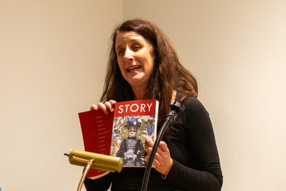 Christie Hodgen holds a book up during her read of her book on Nov. 11. The event took place in the Ulrich Museum of Art.