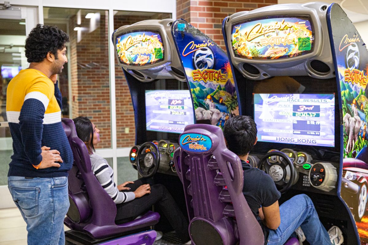 Sreeja Vuyyala, Rajshekav Tangeala and Lalith Rachapudi play a racing game together on Nov. 14. The event was put on by the Student Activities Council.
