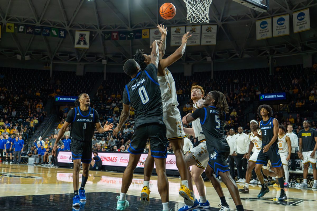 Sophomore Dillon Battie (8) goes up for a shot as a UNC Asheville defender is draped over him on Nov. 4. Battie scored six points in the 75-58 win.