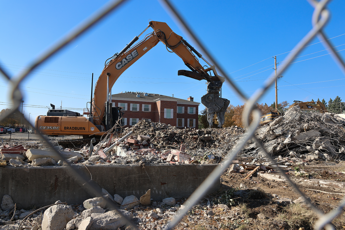 Workers use vehicles to move debris on Nov. 17, 2025, after demolishing Brennan Hall. Brennan Hall was built in 1953 as a dormitory. 