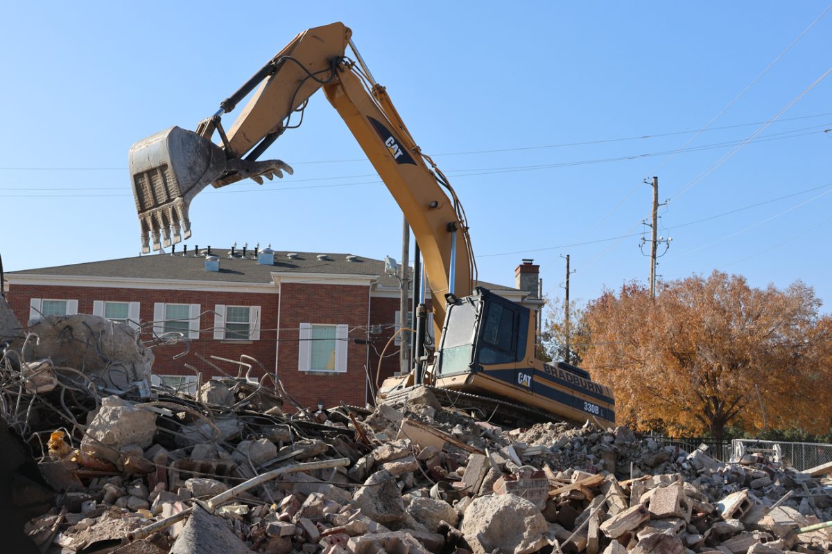 An excavator moves debris on the site of Brennan Hall. Demolition of the former dormitory was completed in November 2025.