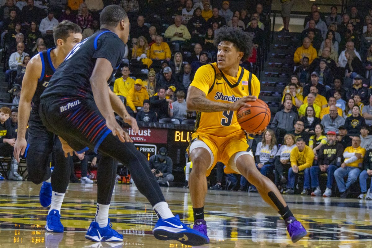 Wichita State men's basketball senior guard Mike Gray Jr. (9) looks for an open teammate on Dec. 13. The Shockers lost to DePaul, 61-58.