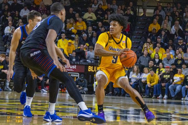 Wichita State men's basketball senior guard Mike Gray Jr. (9) looks for an open teammate on Dec. 13. The Shockers lost to DePaul, 61-58.