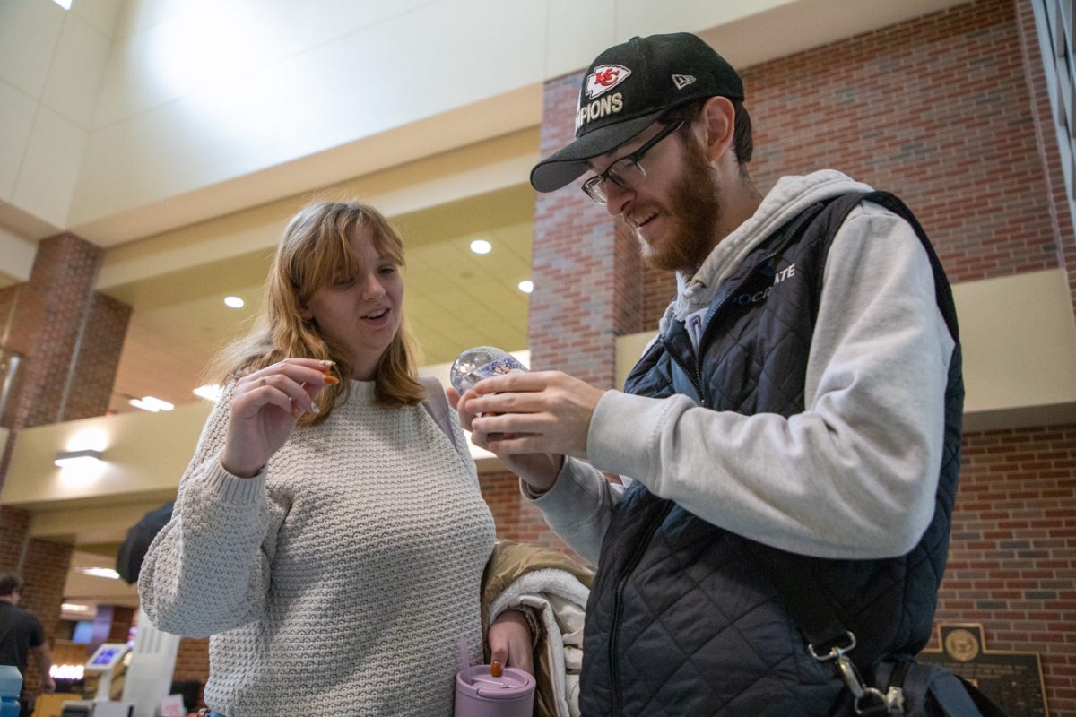 Sophomore Becca Hershberger and Freshman Josiah Armstrong admire their snow-globe. They took an extra one afterward to gift a family member.