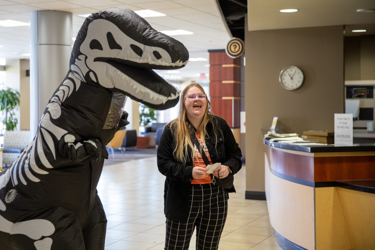 One stop advisors Constantine Gartelos, dressed as a dinosaur, and Raven Garrison dance to music. They were part of the Dino Pep Rally hosted by the Success Teams.