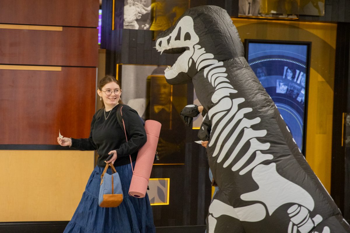One stop advisor Constantine Gartelos wishes luck to senior Allison Waldt for their finals. Gartelos was dressed a dinosaur for a Dino Pep Rally.