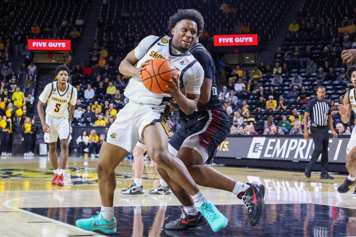 Wichita State men's basketball senior guard Kenyon Giles (1) spins around an Eastern Kentucky defender on Dec. 21. (File photo)