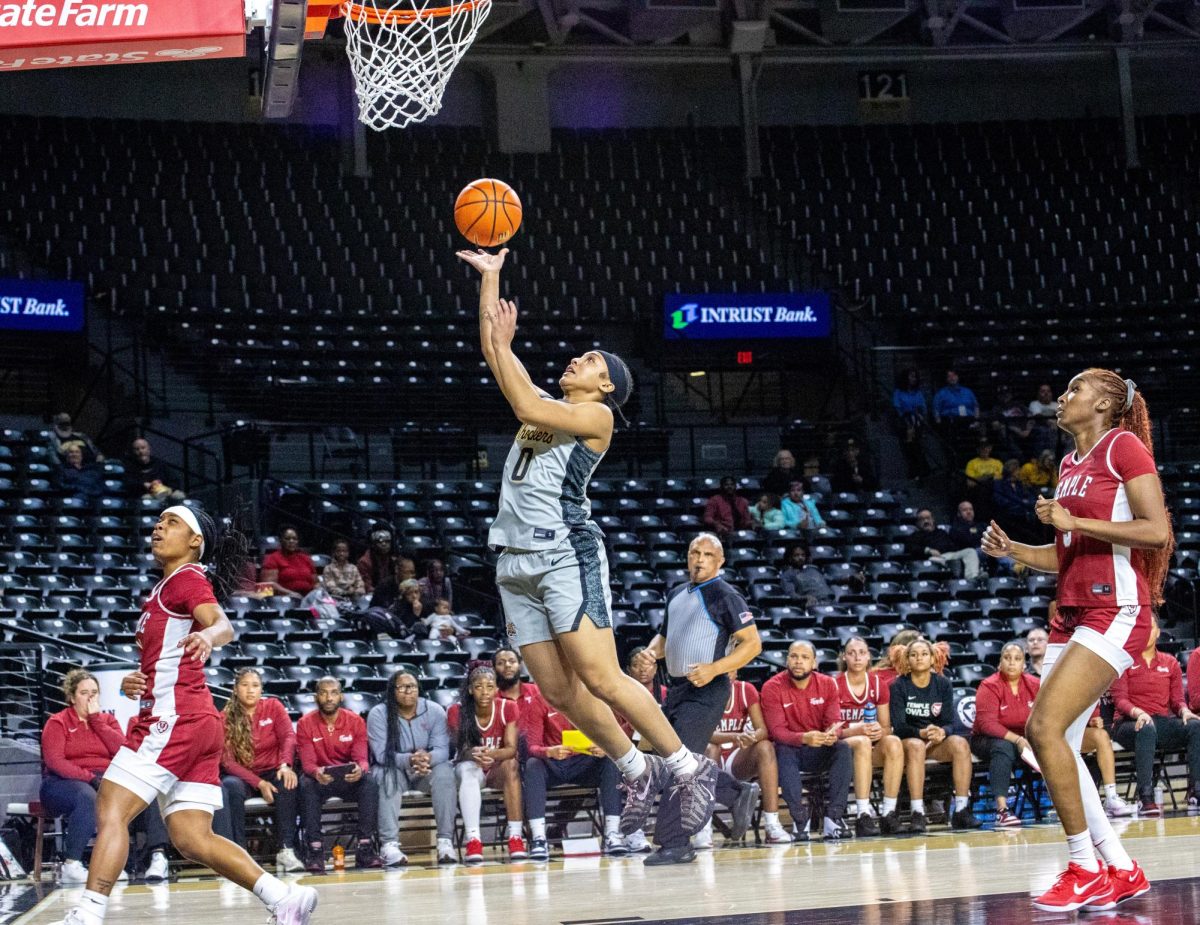 Wichita State women's basketball junior guard Azjah Reeves (0) attempts a layup against the Temple Owls on Jan. 6. The Shockers lost, 70-50.