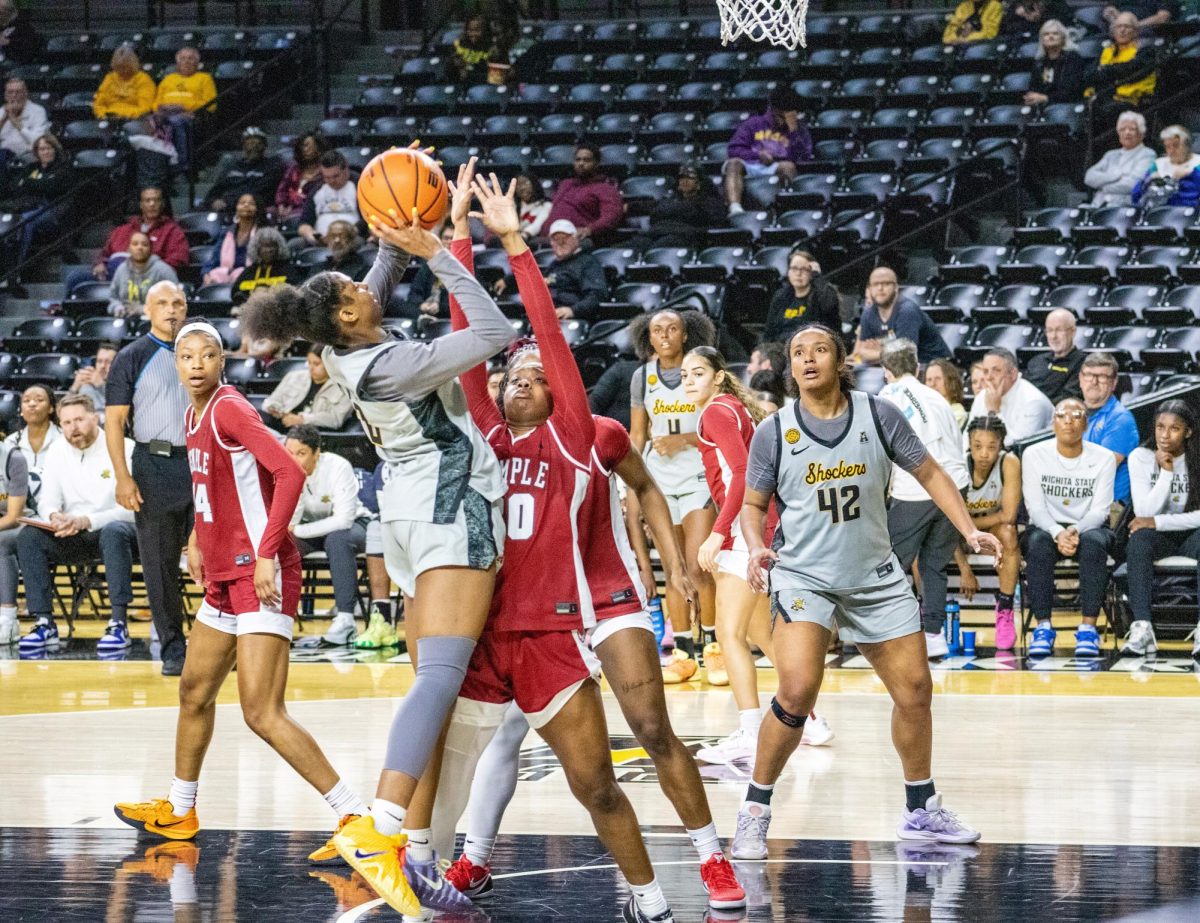 Wichita State women's basketball graduate guard Abby Cater (2) attempts a shot in the paint against a Temple defender on Jan. 6. The Shockers made 10-of-24 of their layups in the 70-50 loss to the Owls.