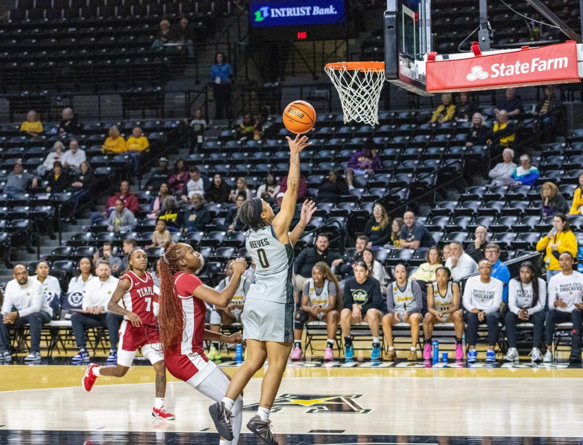 Wichita State women's basketball junior guard Azjah Reeves (0) attempts a layup against the Temple Owls on Jan. 6. Reeves scored seven points in the 70-50 loss.