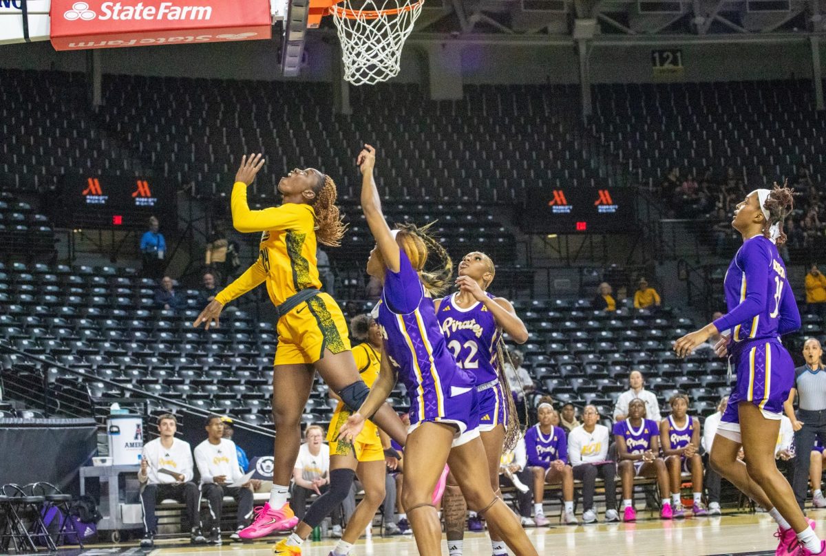 Wichita State women's basketball senior forward Maimouna Sissoko (24) gets fouled on a shot attempt by an East Carolina Pirate on Jan. 10. The Shockers went 17-for-28 at the foul line but lost, 83-56.