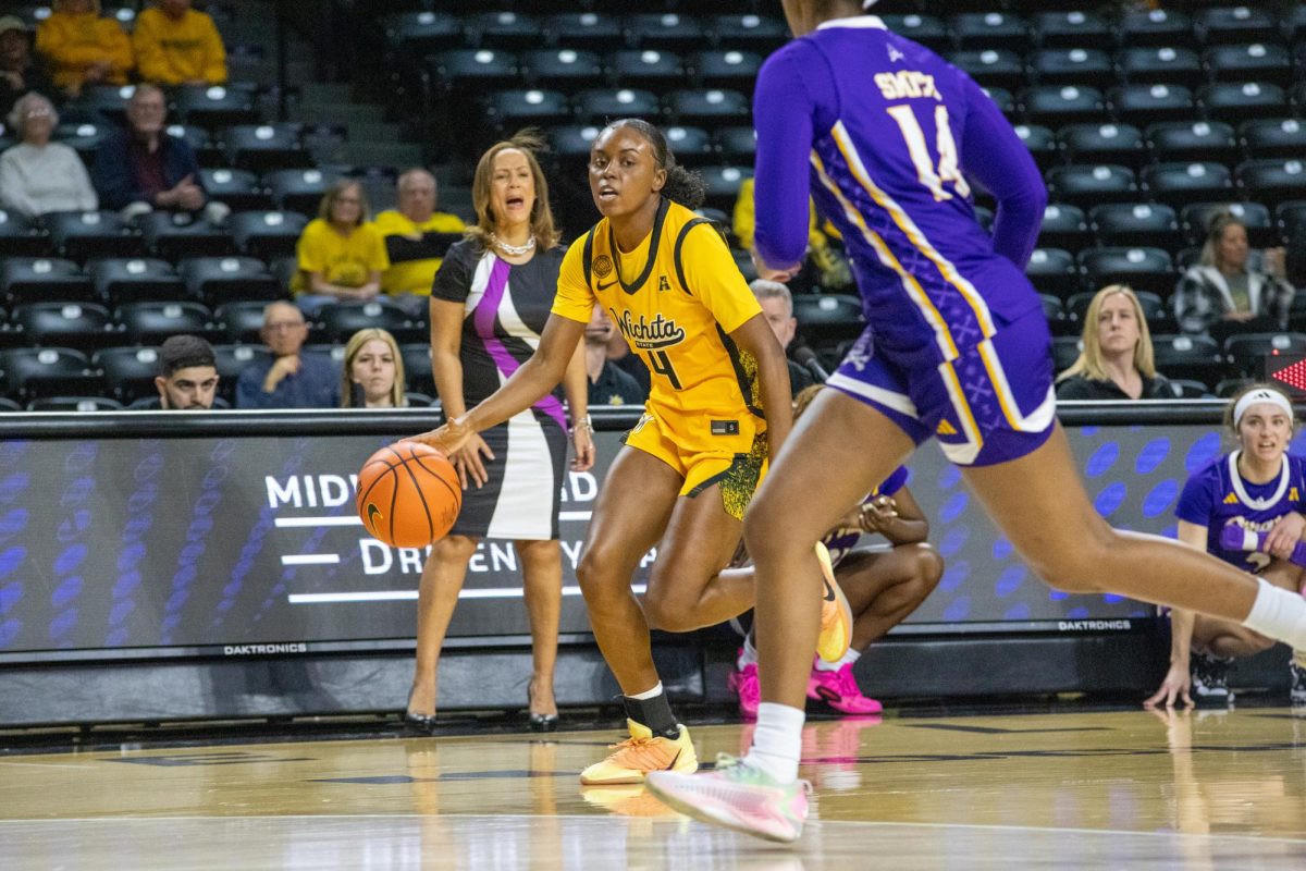 Wichita State women's basketball graduate guard Jaila Harding (4) dribbles the ball up the court on Jan. 10. Harding finished the game against East Carolina with nine points on 3-of-10 shooting.