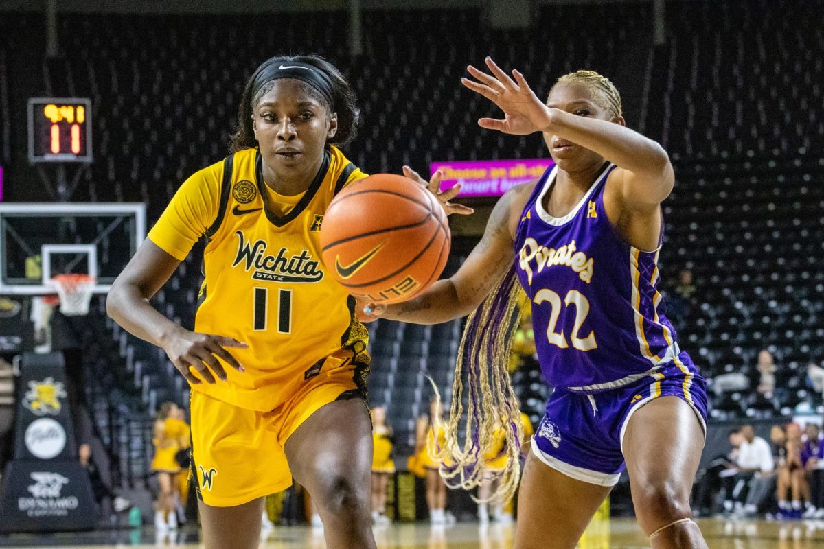 Wichita State women's basketball junior forward Jaida McDonald (11) fights to keep possession of the ball against an East Carolina defender on Jan. 10. The Shockers turned the ball over 27 times, which led to 34 points for the Pirates.