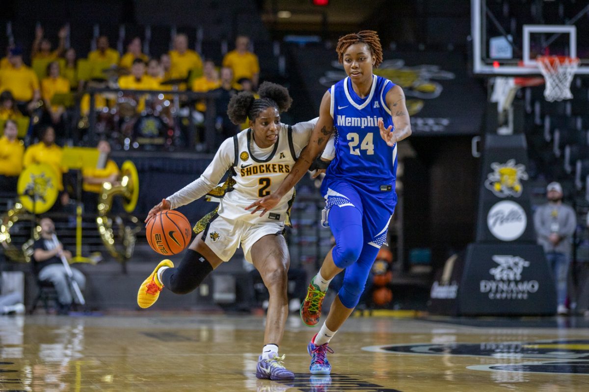 Wichita State women's basketball graduate guard Abby Cater (2) brushes off a Memphis player on Jan. 20. Cater scored 42 points in the Shockers' 66-59 win, which set a program record.