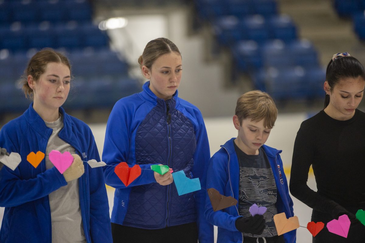 Members of the Wichita Figure Skating Club stand for a moment of silence for the victims of Flight 5342 at the Wichita Ice Center. The moment of silence was held at 4:45 p.m. on Jan. 29.